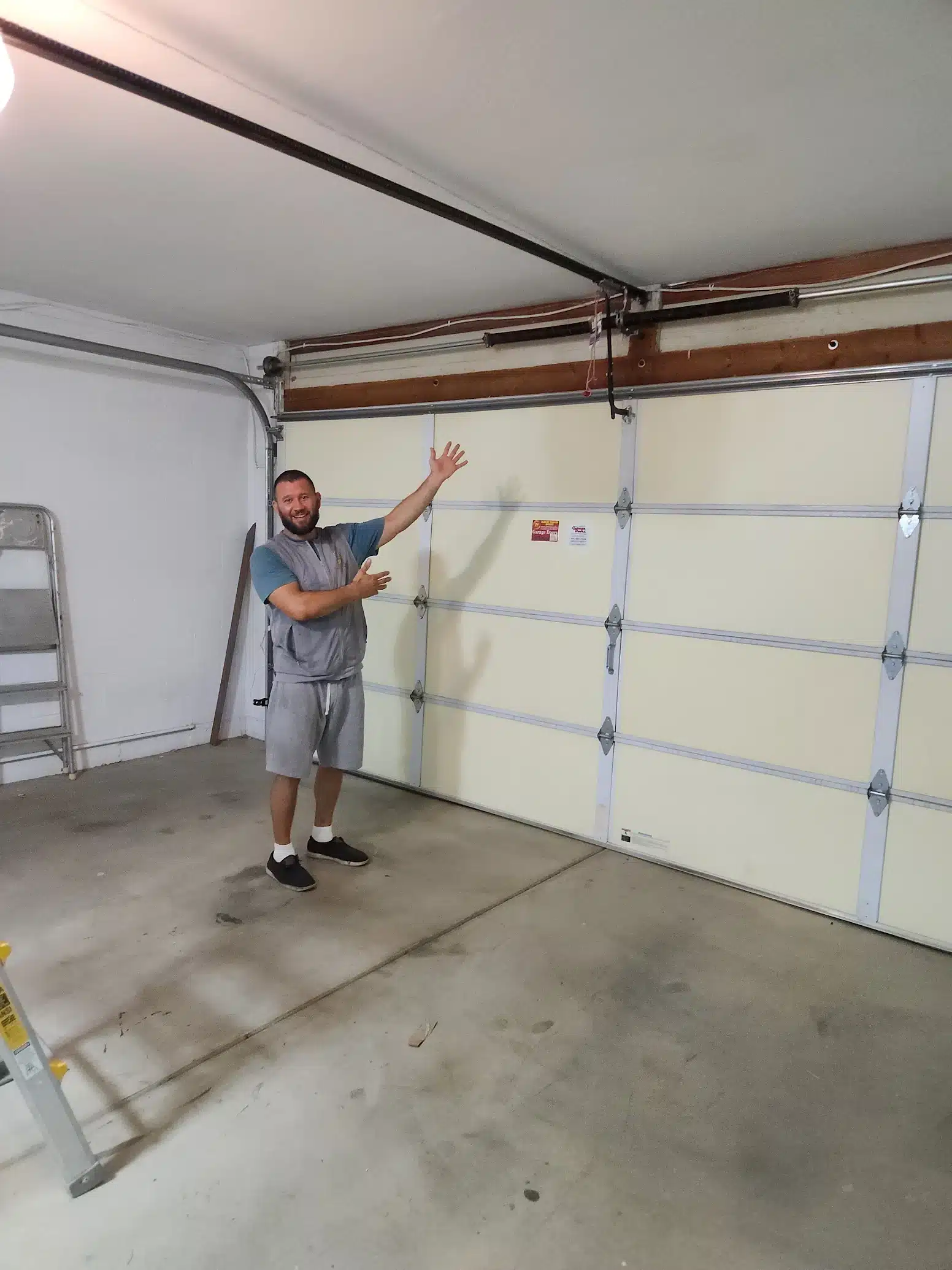 Eric repairing a garage door near Glendale Arizona