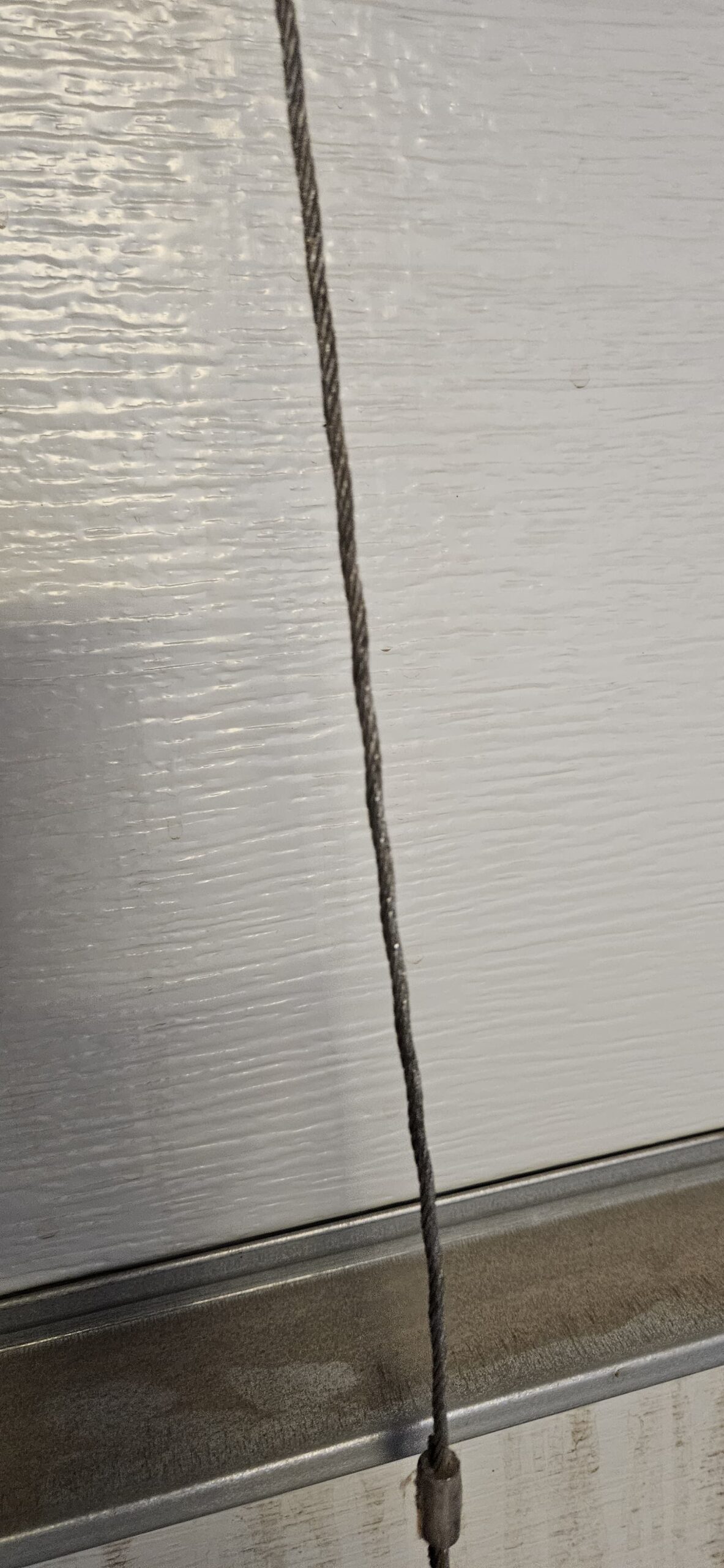 Damaged garage door cable found during repair
