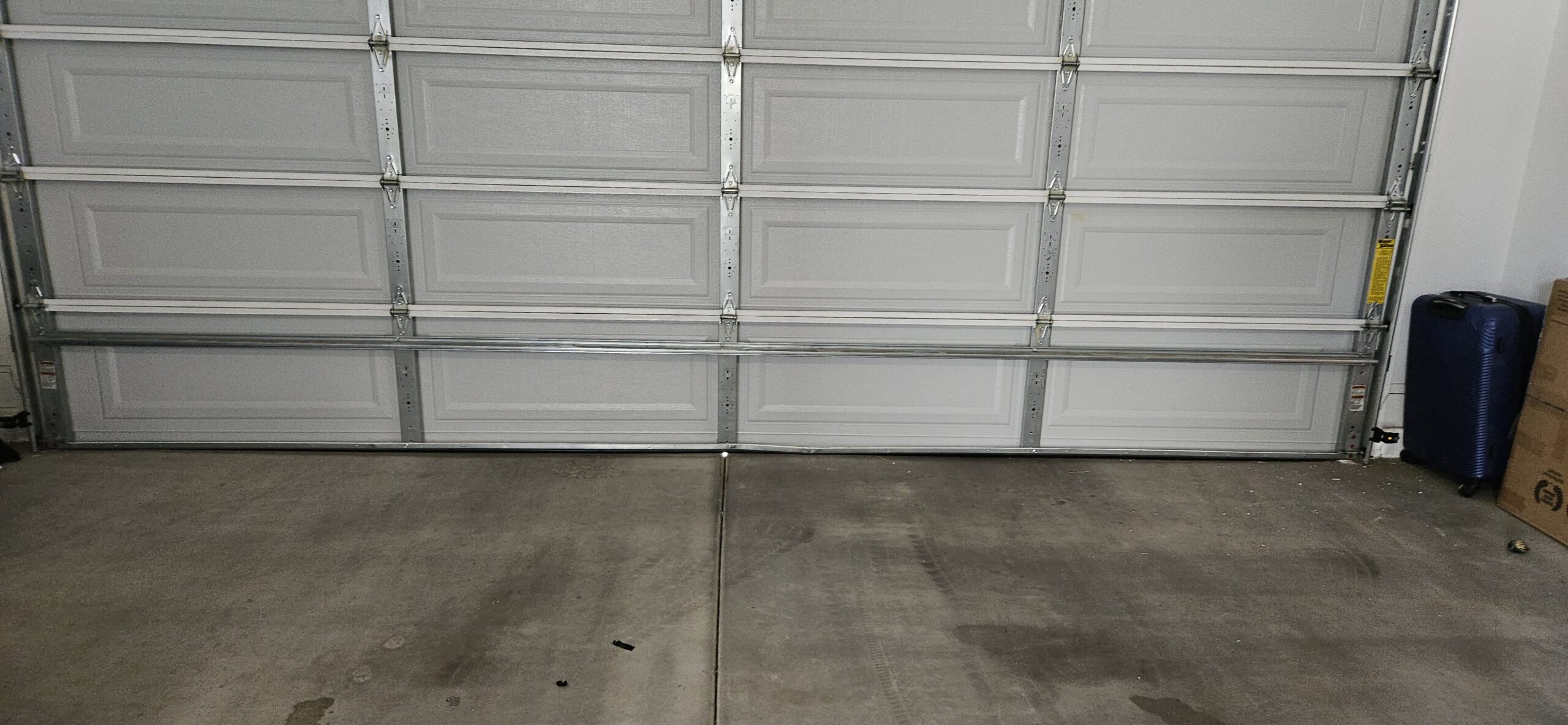 Garage door sitting evenly against the floor after repair in Waddell