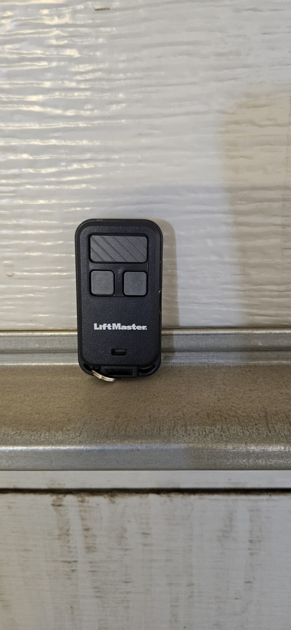 New garage door remote controller programmed for homeowner