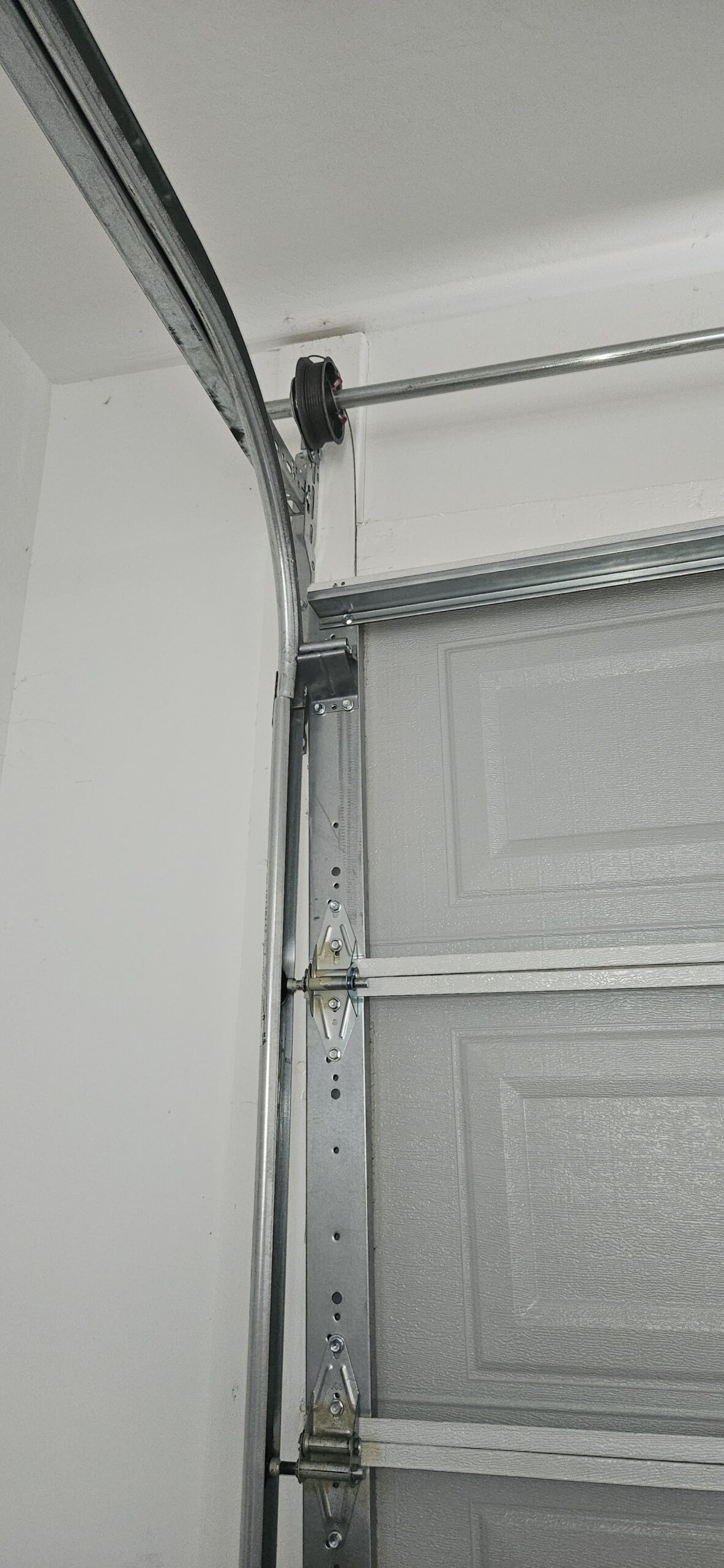 Garage door roller out of position before off-track repair in Waddell