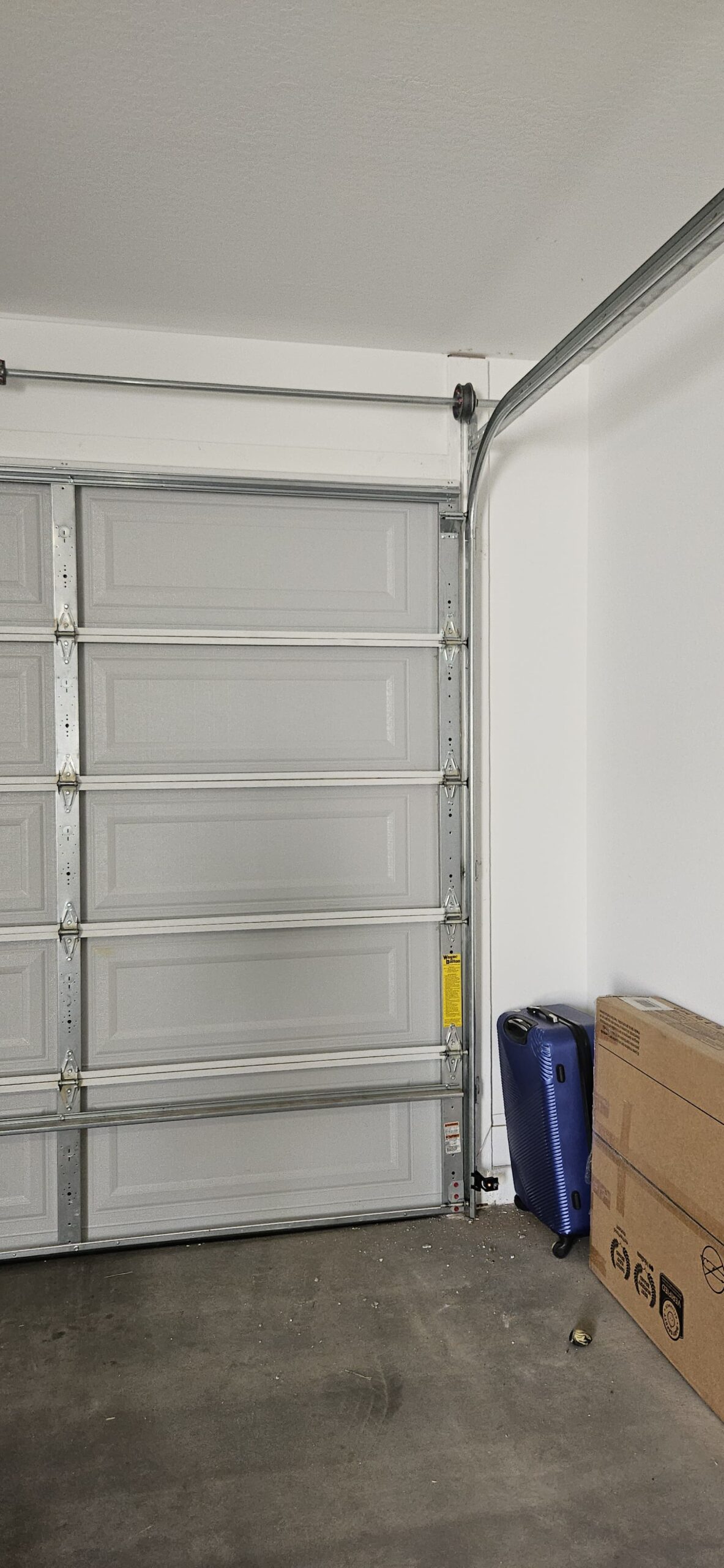 Garage door rollers aligned with the track after repair in Waddell