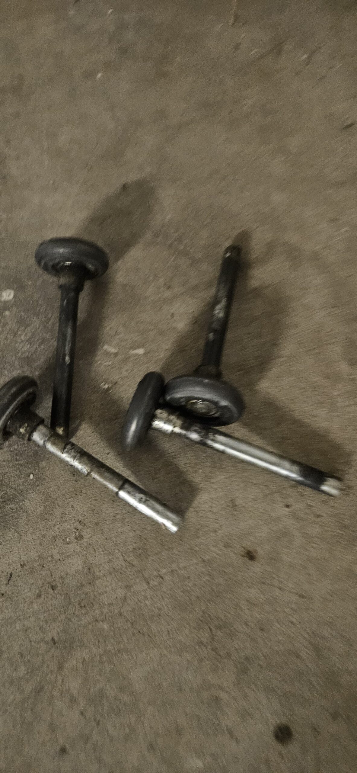 Removed worn garage door rollers close up